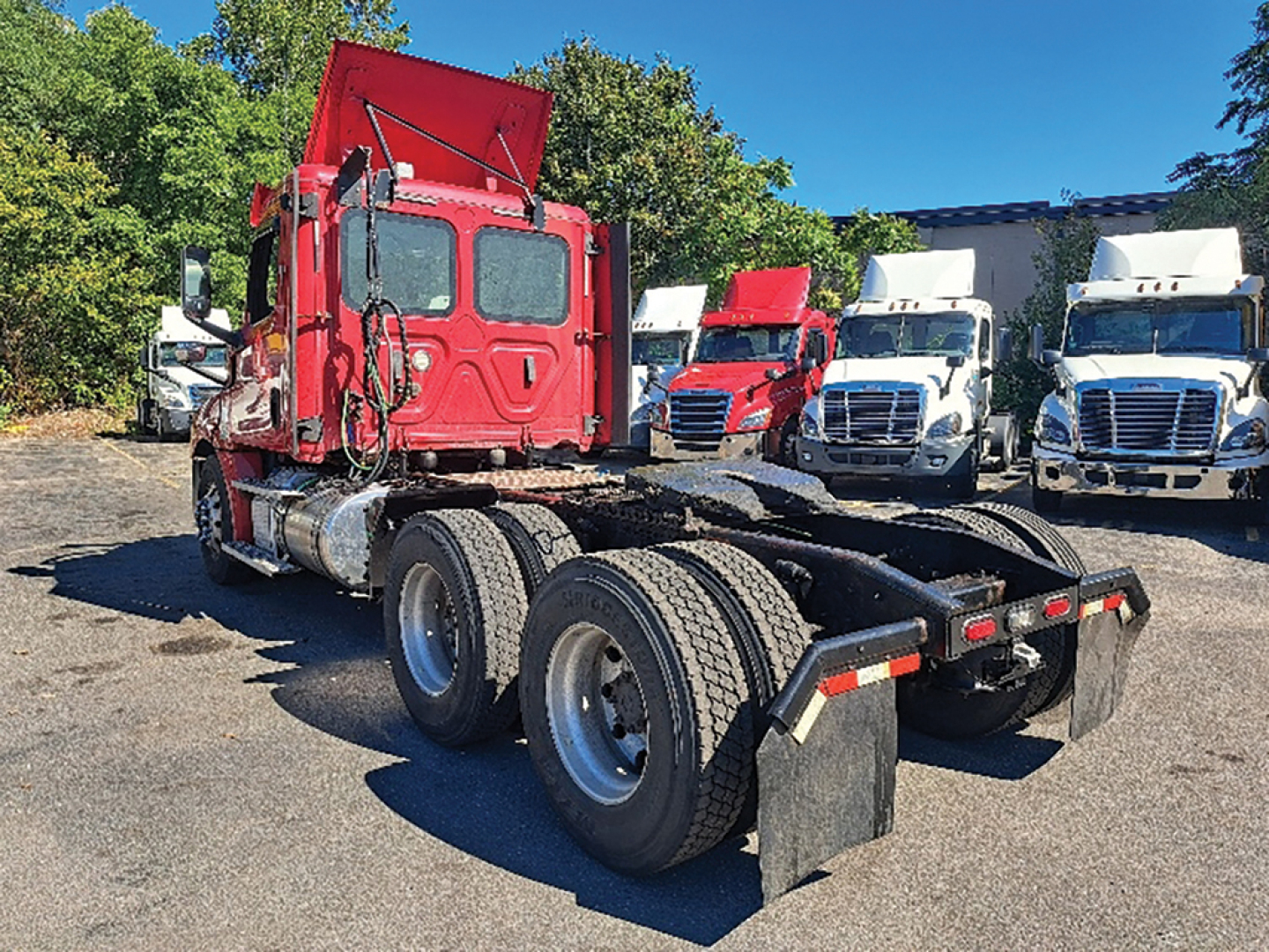 Freightliner Cascadia126 truck chassis rear view showing dual rear axles and red cab.