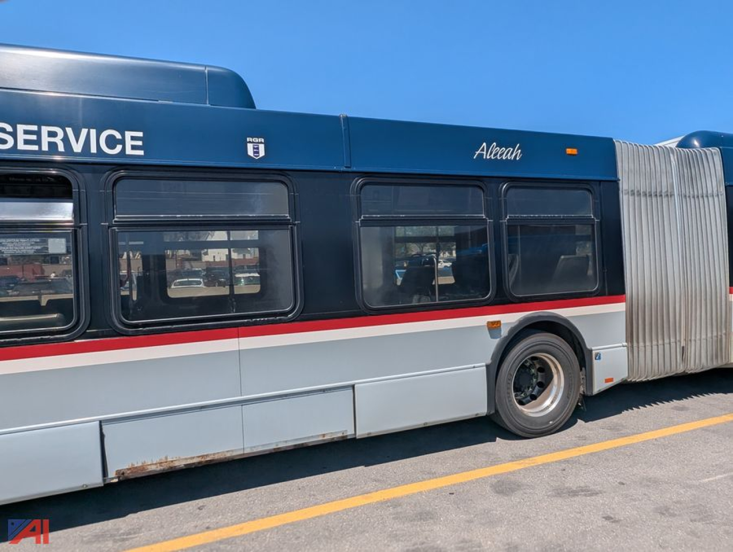 Bus side view showing XD60 transit bus with 'SERVICE' lettering, blue top, white body with red stripe, wheel and accordion cloak visible.