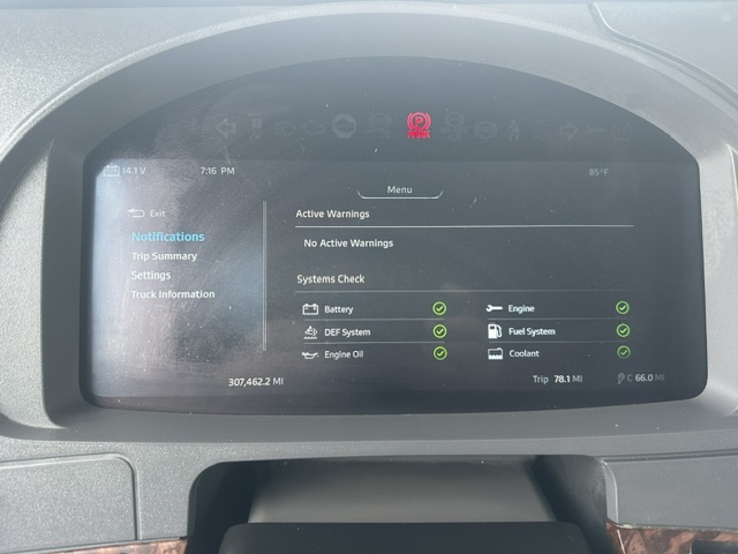 Kenworth T880 dashboard display showing trip info and active warnings; indicators for engine, DEF system, engine oil, fuel system, coolant, and battery; VIN and stock number not visible on screen.