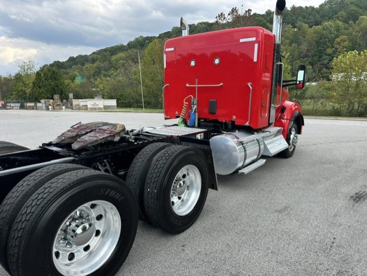 Kenworth T880 truck rear chassis and cab in red with sleeper, dual rear axles, chrome fuel tanks, and fifth wheel visible.