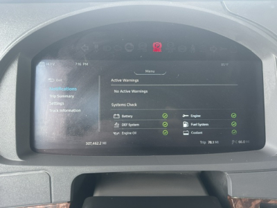 Kenworth T880 dashboard display showing trip info and active warnings; indicators for engine, DEF system, engine oil, fuel system, coolant, and battery; VIN and stock number not visible on screen.