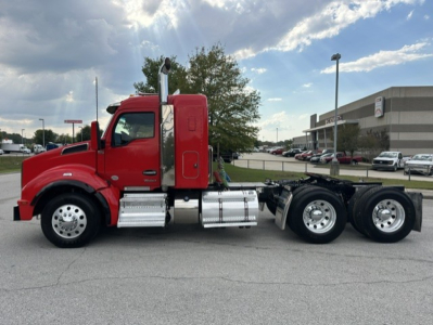 Kenworth T880 tractor profile side view showing red cab with chrome fuel tanks and dual rear axles.