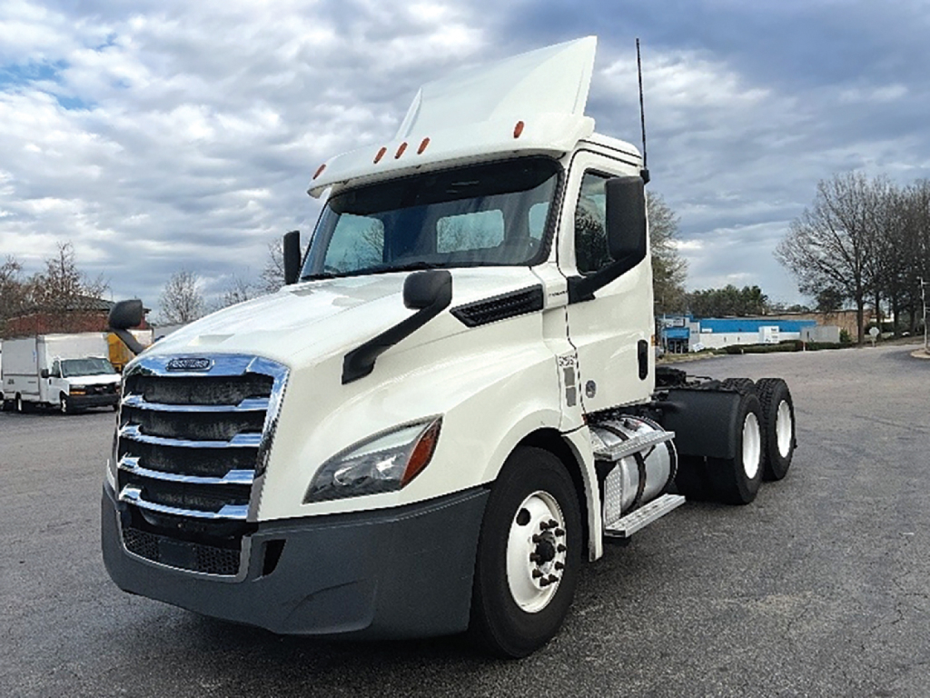 Front-left side view of a white Freightliner Cascadia126 day cab truck with raised sleeper, showing chrome grille, tall aerodynamic mirrors, and dual rear axles.