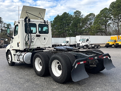 2019 Freightliner Cascadia126 daycab tractor showing rear view with mud flaps and fifth wheel area.