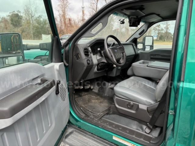 Ford F-550 cab interior showing driver seat and dashboard view from open door.