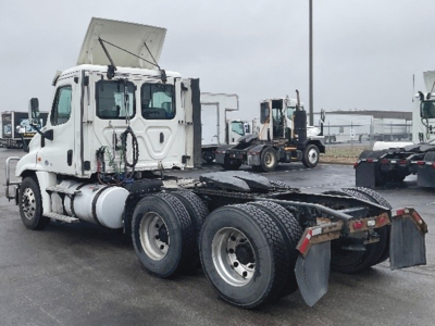 Freightliner Cascadia125 tractor with daycab configuration from rear-left view, showing chassis and fifth wheel area.