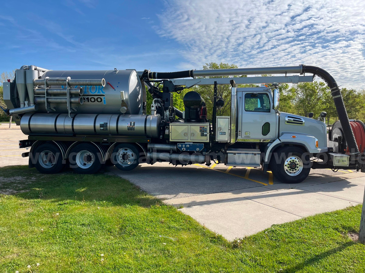 Wide side view of a 2020 Western Star Vactor 2100PD sewer jet/vac truck showing large vacuum tank, hose reel, and extended exhaust/boom with operator cab.