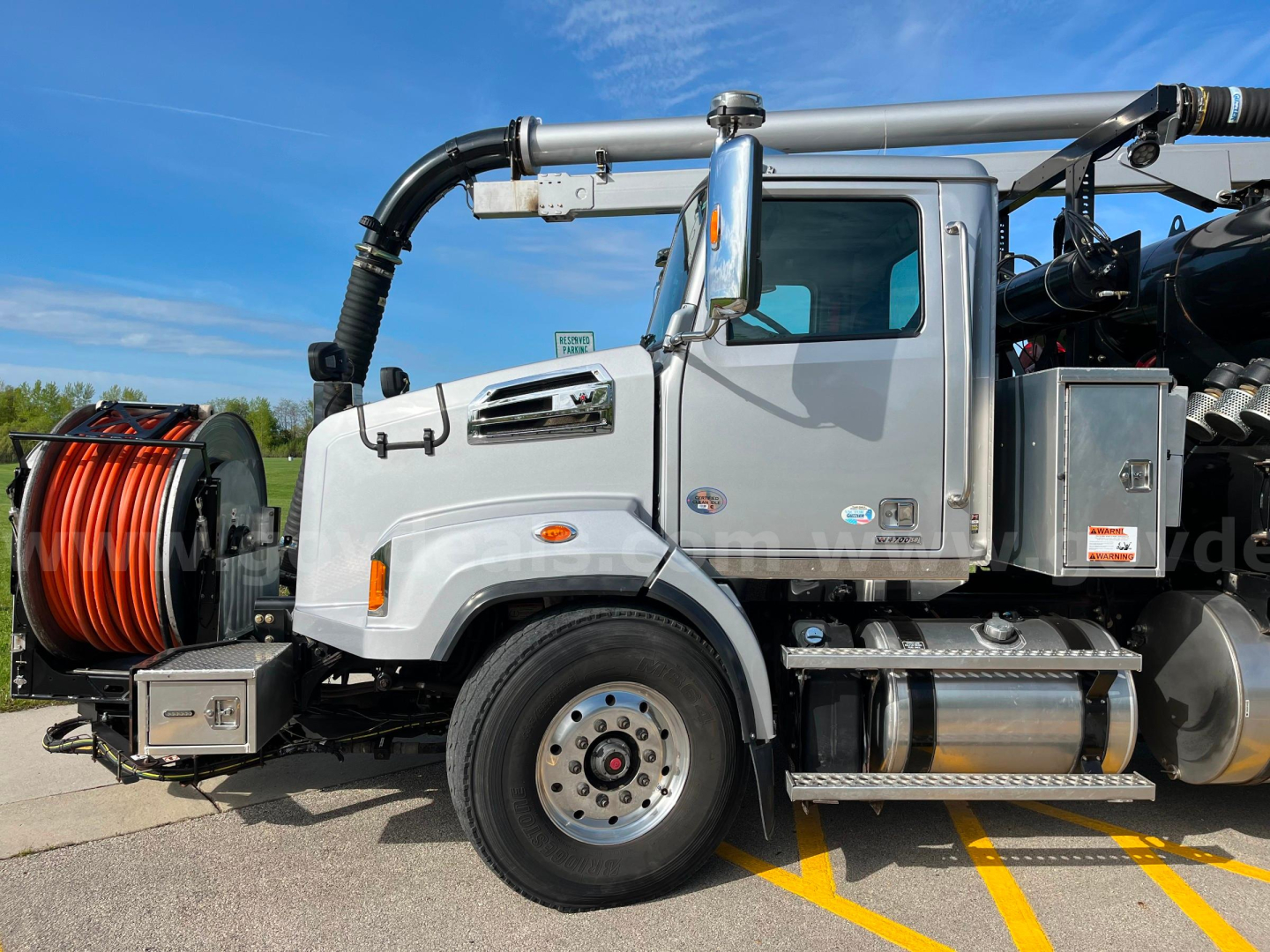 Vehicle side view: 2020 Western Star Vactor 2100PD sewer cleaner truck with front cab, water tank, hose reel, and vacuum hose assembly.
