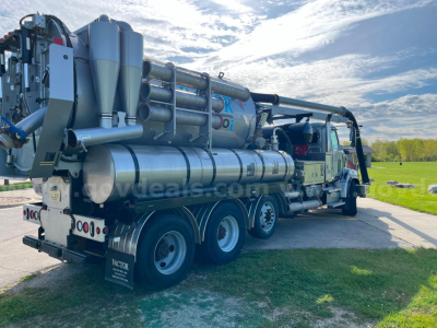 Western Star Vactor 2100PD sewer jet/vac truck side view showing multiple large vacuum tanks and hoses mounted on a long dual-axle chassis.