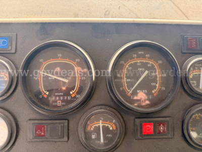 Oshkosh PA-2523-3 truck instrument cluster showing gauges and indicators; fuel gauge, speedometer, and warning lights visible.
