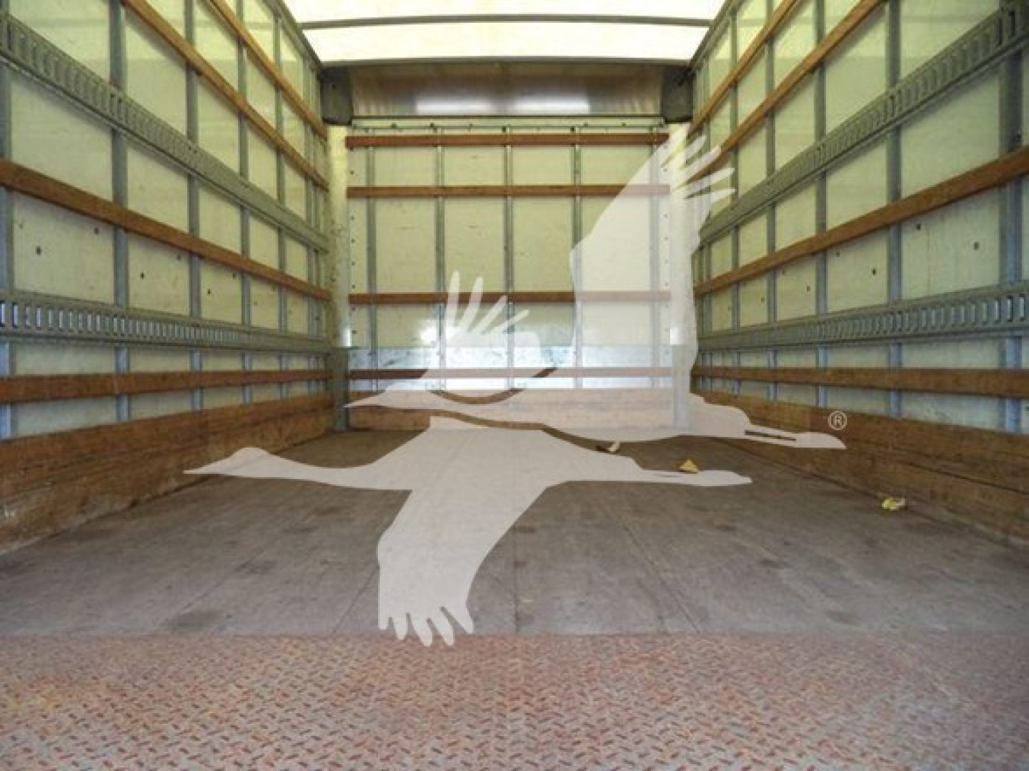 Empty cargo box of a 2021 Isuzu NPR HD truck showing interior walls and floor.
