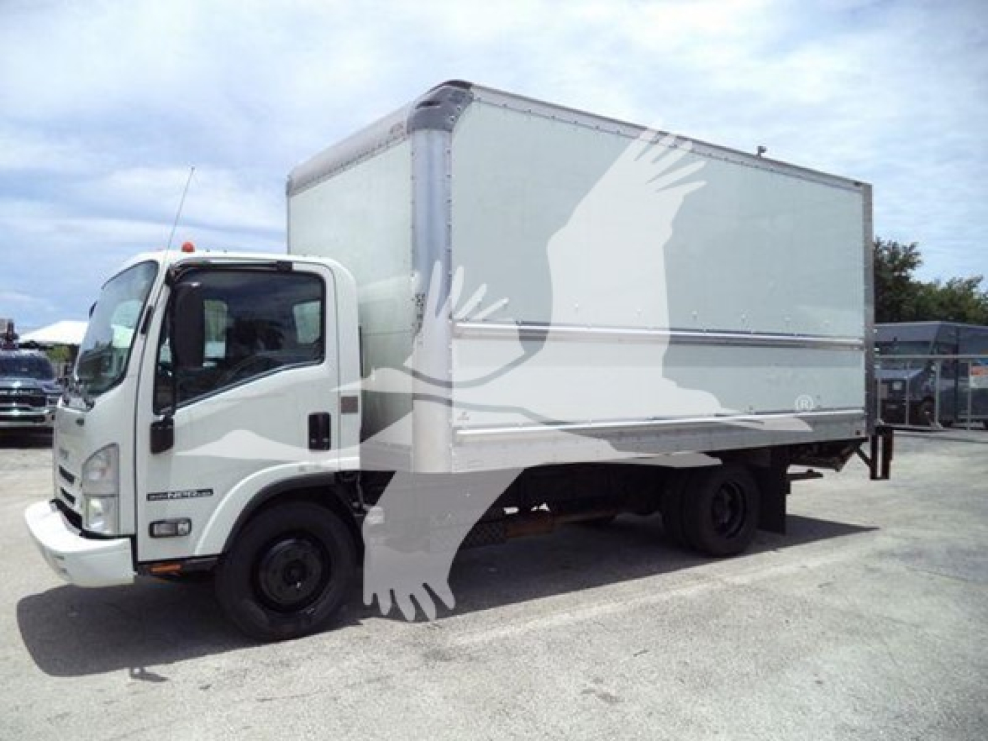 Isuzu NPR-HD box truck in-service showing side view with cargo box and front cab.