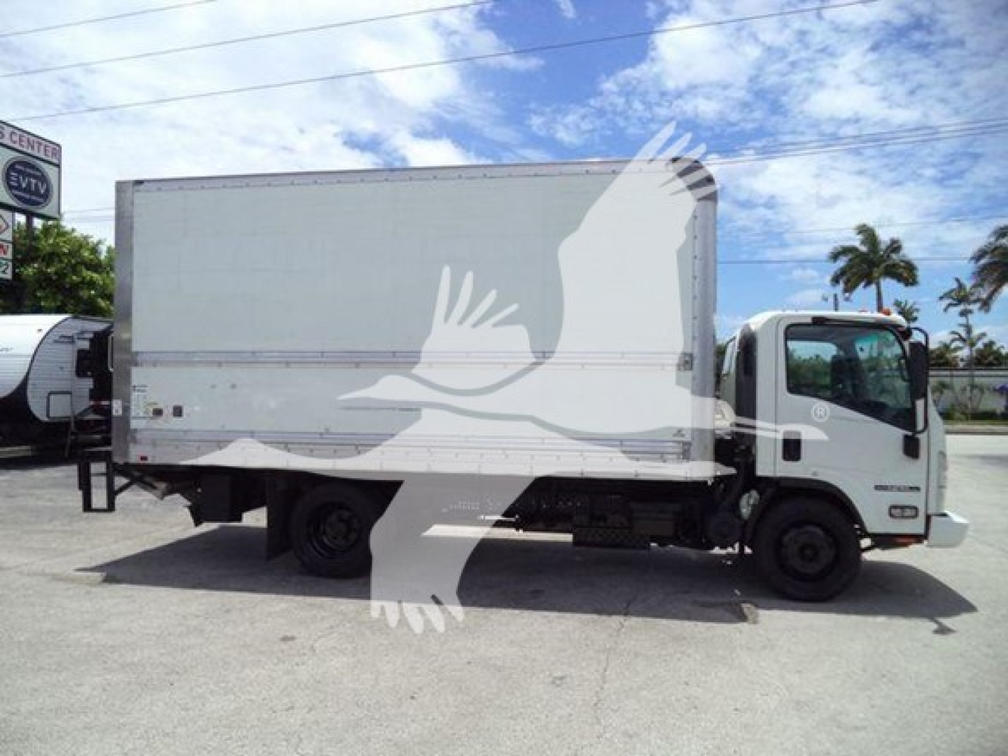 Isuzu NPR HD box truck side view with white cargo box and cab, no visible text on the box