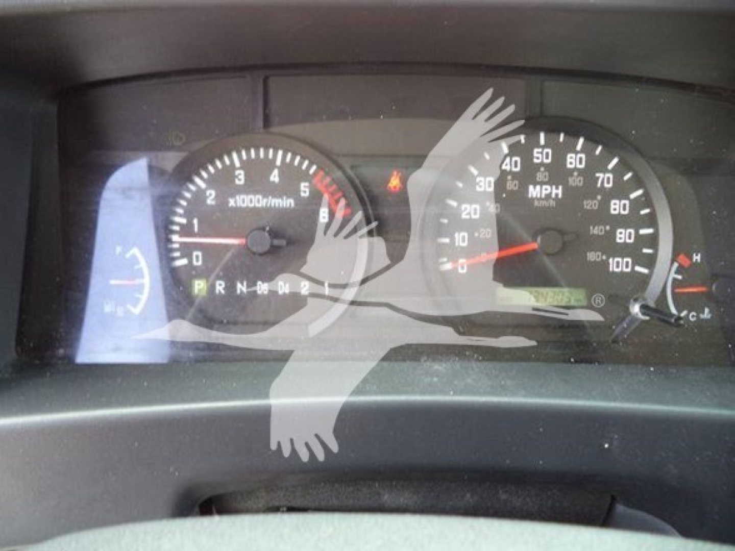 Dashboard of a 2021 Isuzu NPR HD showing tachometer and speedometer with gear indicator PRN D 0 4 2 and warning lights.