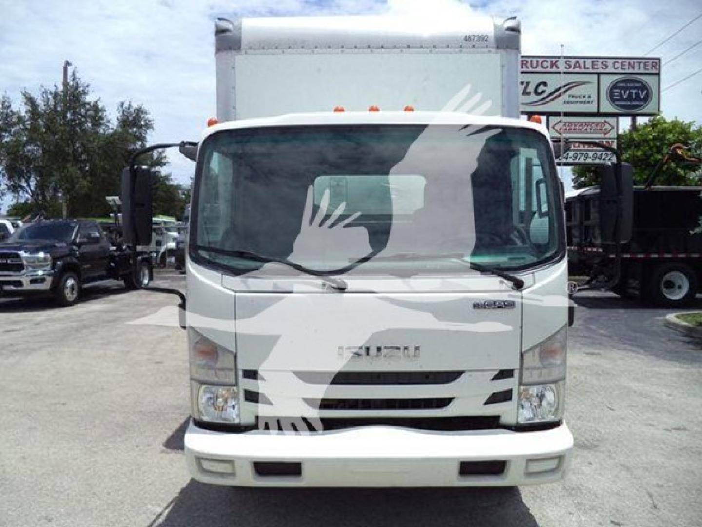Isuzu NPR-HD box truck front view showing windshield and cab with Isuzu emblem.