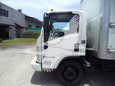Isuzu NPR HD box truck cab side view showing steering wheel, door, window, and part of cargo body.
