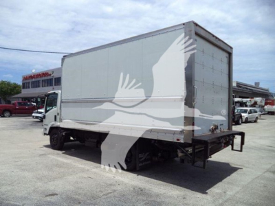 Isuzu NPR-HD box truck rear-side view showing cargo box and rear lift.