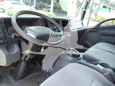 Isuzu NPR HD interior showing steering wheel, dashboard, and front passenger seat.