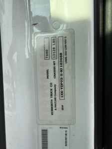 Kenworth T680 truck door sticker with model, weight, and serial information. Visible text includes MODEL 60???, CHASSIS WEIGHT, etc.