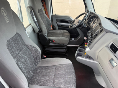 Kenworth T680 truck interior showing front seats and dashboard.