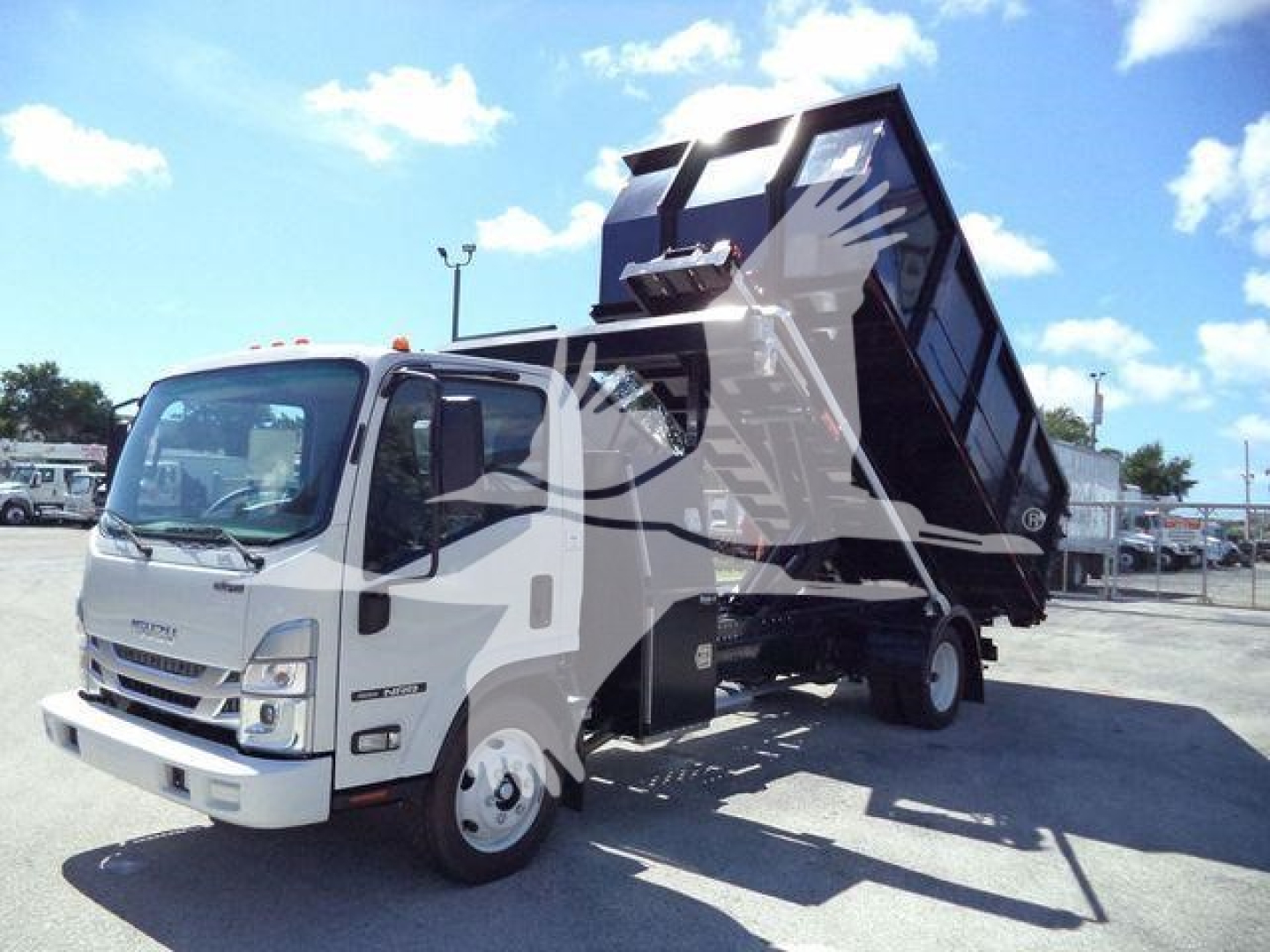 Isuzu NPRR truck with a raised dump bed in a roll-off configuration, white cab and black hopper, front left view.