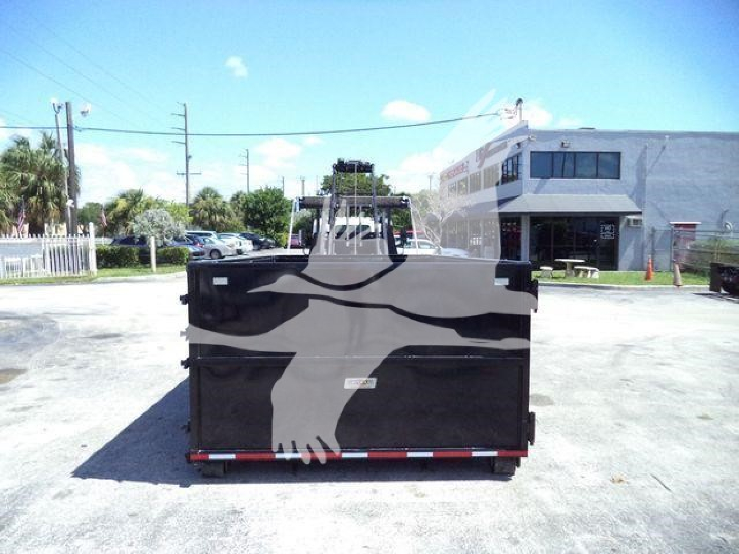 Isuzu NRR roll-off truck bed rear view with graphic of eagle wings and stock number GASNRR14SNG.