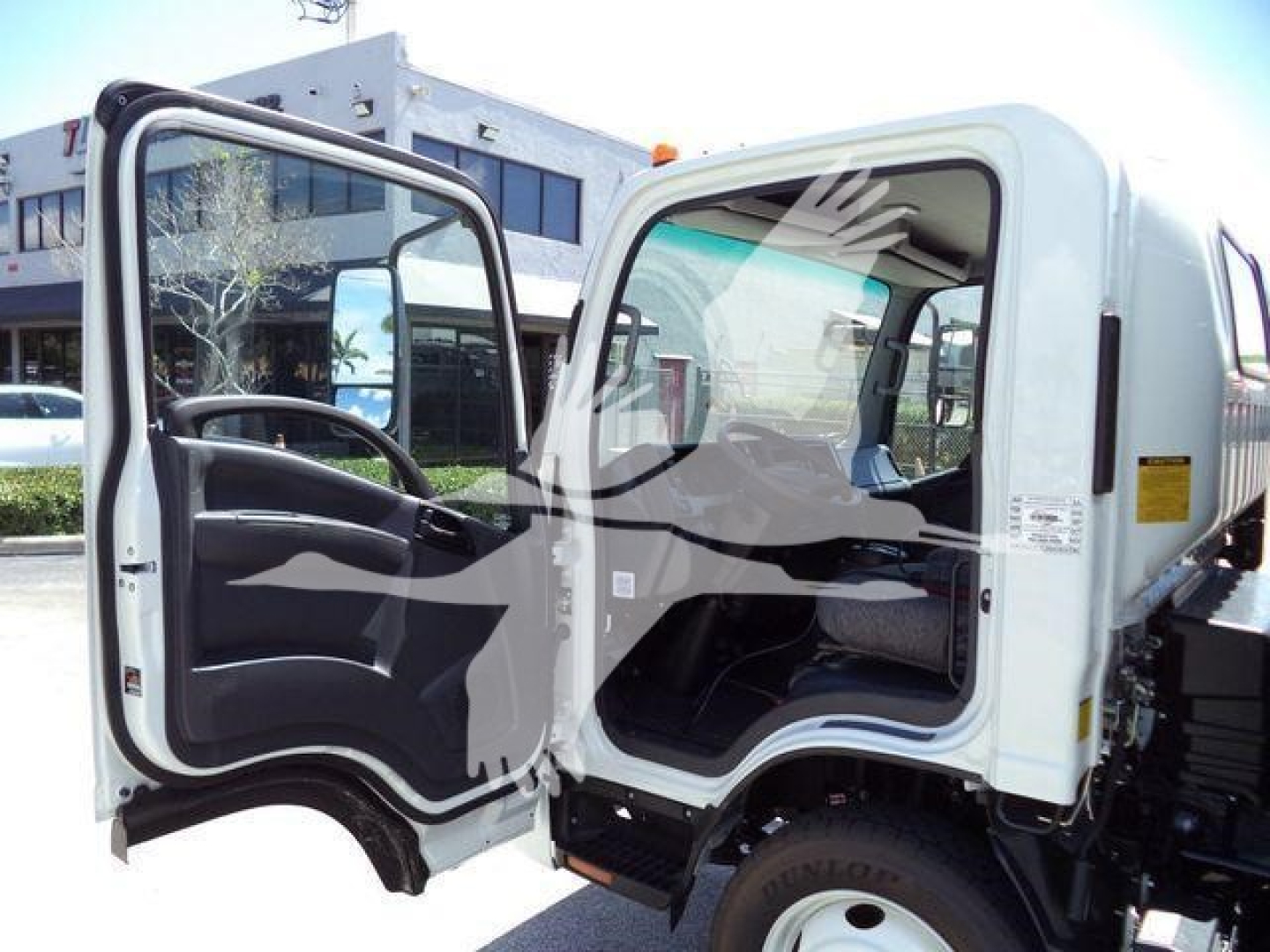 Isuzu NPRR rolloff truck cab with open door showing interior. Visible text includes stock number GASNRR14SNG and category trucks new.