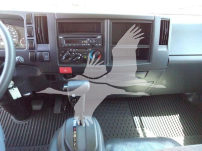 Isuzu NPRR dashboard and center stack showing climate controls and radio with manual gear selector visible