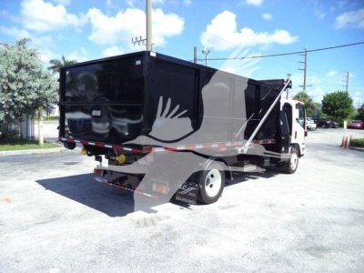Isuzu NPRR roll-off truck shown from rear-left with black cargo container and white cab.