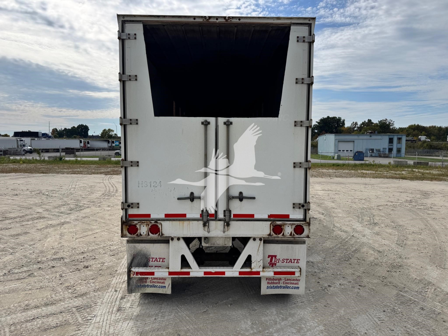 Trailer rear showing open chipping box, rear doors, and taillights of a 2014 Wabash chip trailer; stock number 7897, VIN 1JJV422DXEL836501.