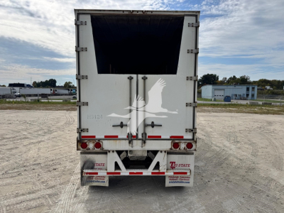 Trailer rear showing open chipping box, rear doors, and taillights of a 2014 Wabash chip trailer; stock number 7897, VIN 1JJV422DXEL836501.