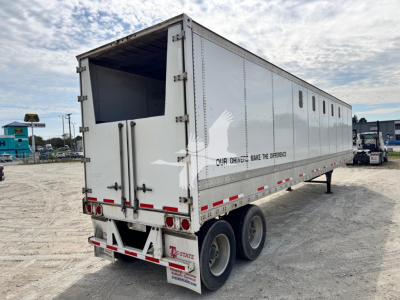 Trailer side with wedge image and text OUR DRIVERS MAKE THE DIFFERENCE along with rear lights and dual rear tires.
