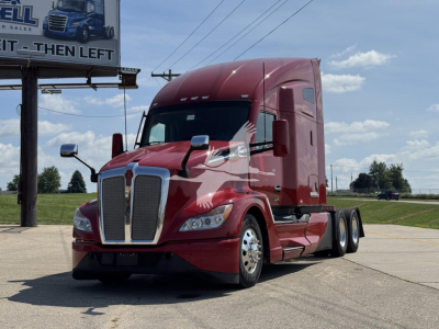 Kenworth T680 tractor-trailer in red, front three-quarter view, with sleeper cab and chrome grille; no visible text on the vehicle.