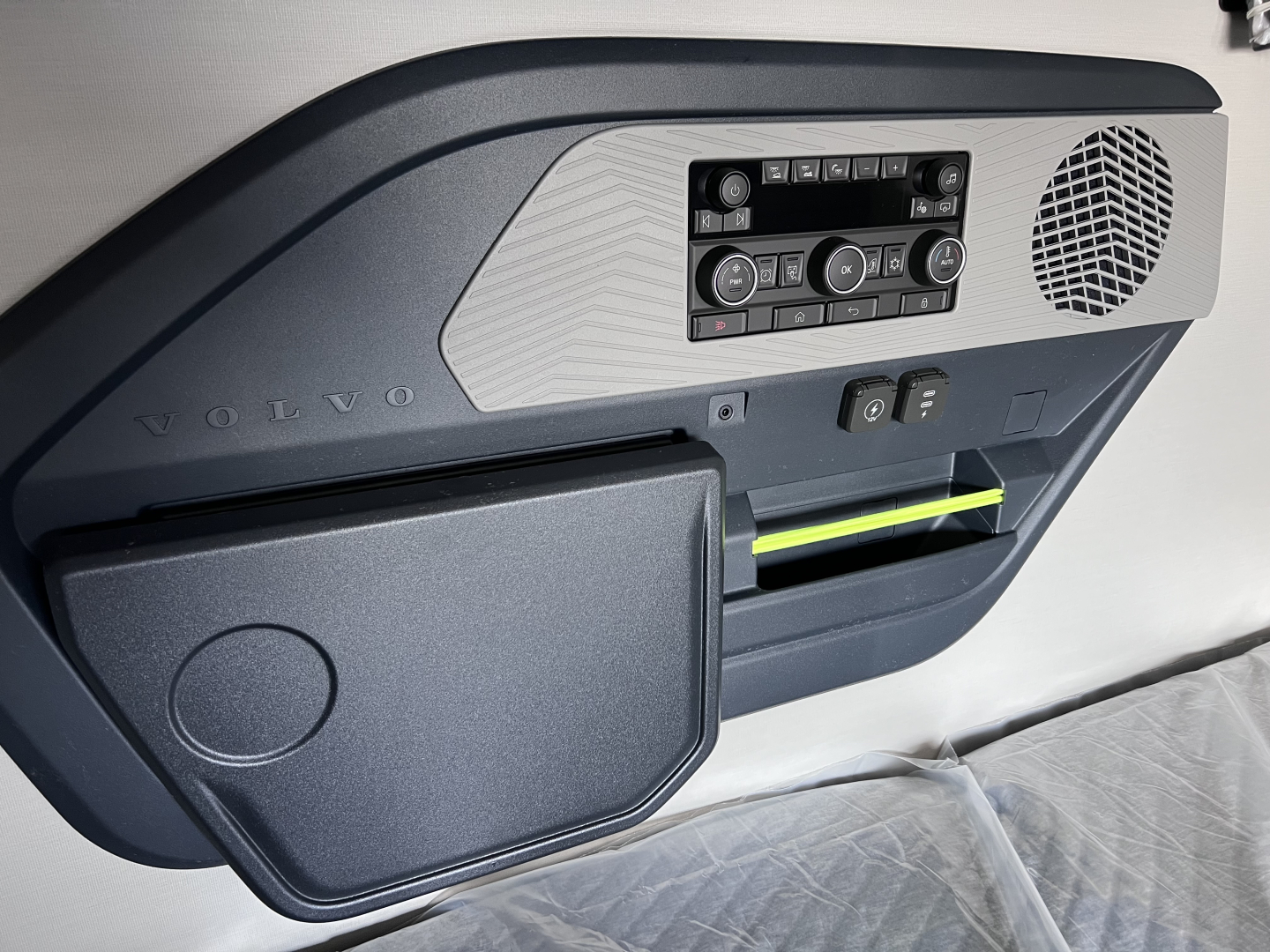 Volvo VNL64T840 dashboard area and passenger-side glove box with control panel and storage pocket.