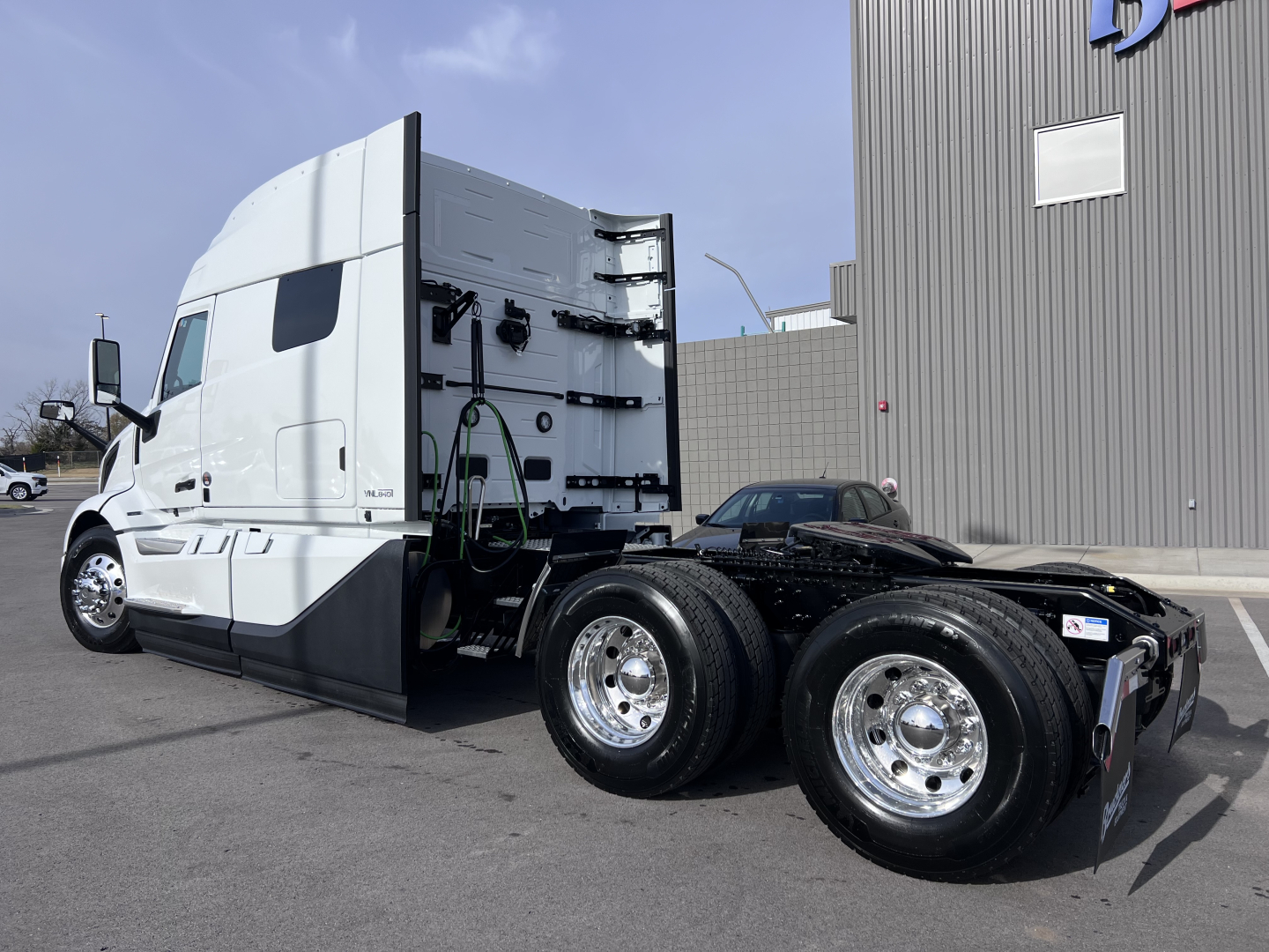 Volvo VNL64T840 truck tractor side view showing tandem rear wheels and sleeper cab.