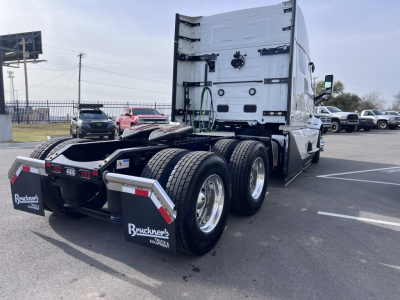 Volvo VNL64T840 truck rear view showing dual rear axle and fifth-wheel connection with mudflaps and Bruckner's logos.