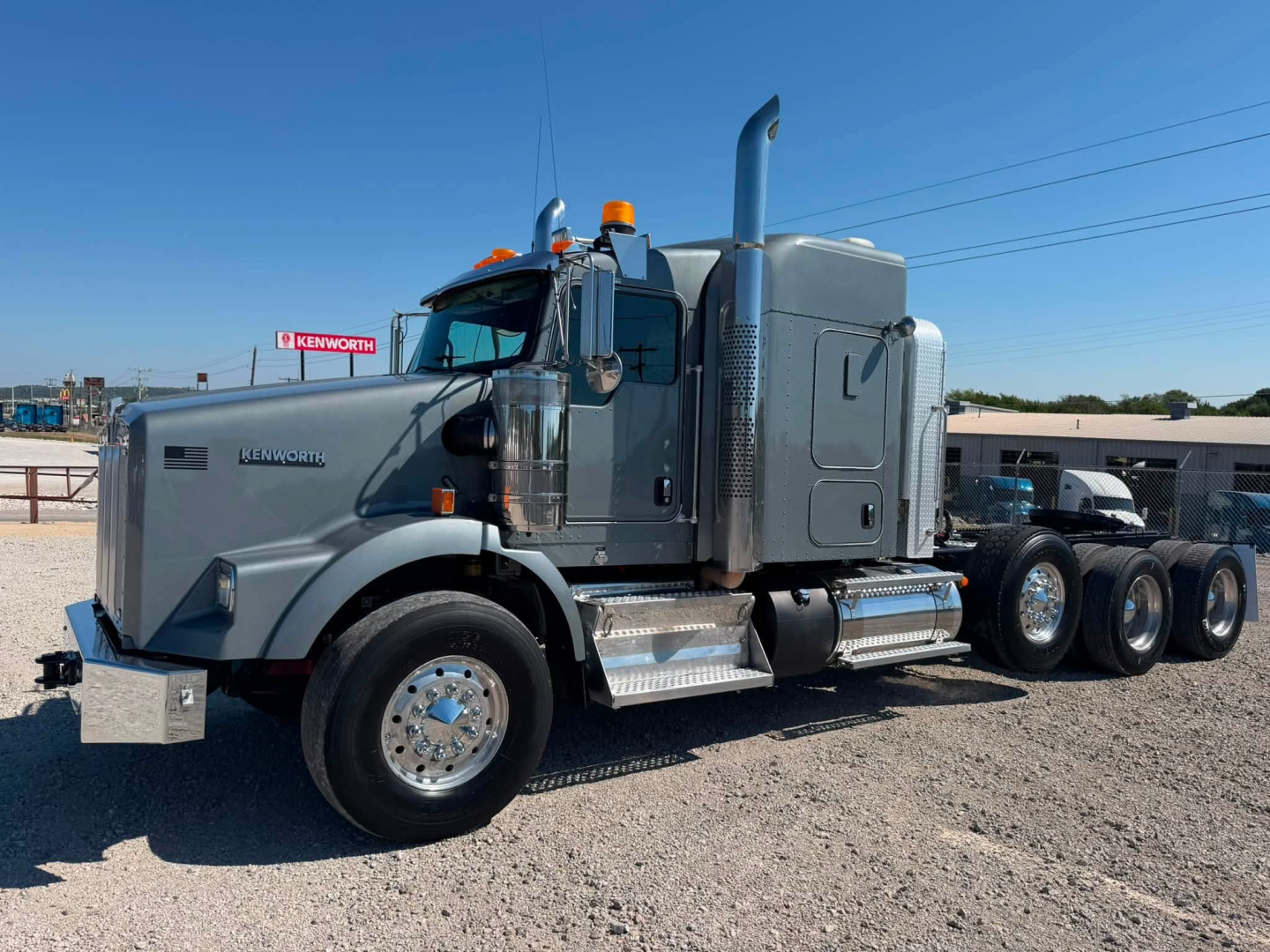 Kenworth T800W conventional sleeper truck in profile view showing cab, chrome steps, dual rear axles, and fuel tanks.