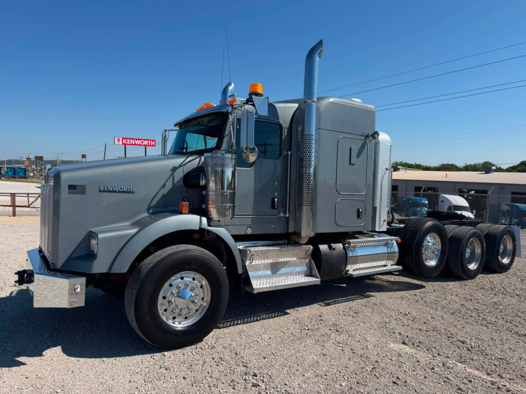 Kenworth T800W conventional sleeper truck in profile view showing cab, chrome steps, dual rear axles, and fuel tanks.