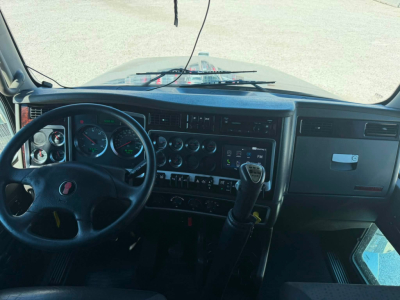 Kenworth T800W truck interior dash and steering wheel with transmission shifter visible.