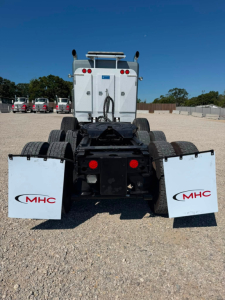 Kenworth T800W rear view showing chassis, wheels, and mud flaps with MHC logo.
