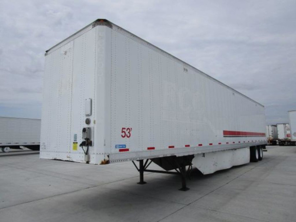 Stoughton 53' van trailer on its landing gear with white exterior, side markings, and rear doors.
