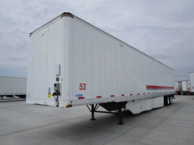 Stoughton 53' van trailer on its landing gear with white exterior, side markings, and rear doors.