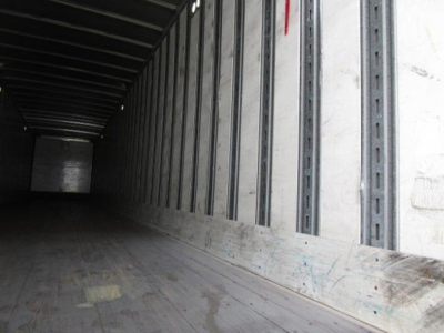 Stoughton van interior trailer with wooden floor and metal side walls showing cargo area.