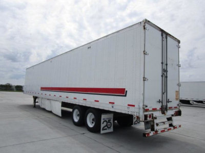 Stoughton van trailer showing side and rear with red reflective stripe and triple-axle configuration.