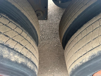 Trailer dual rear tires in view with tread worn and road grime; part of a Utility 4000Dx trailer showing tire pair.