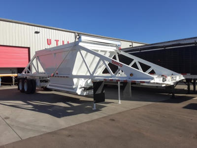 Ranco LW21-40 dump trailer showing dual-axle chassis and triangular frame, white with red branding.