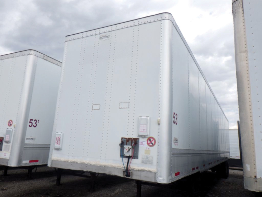 Trailer side and front of a white Wabash Duraplate HD van trailer showing the front interior with coupling and wiring; no legible model text visible