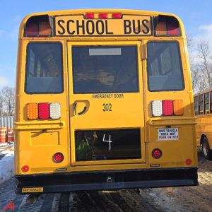 Rear view of a yellow 2014 Freightliner B2 school bus with 'SCHOOL BUS' sign, rear door, emergency door label, and bus number 302.