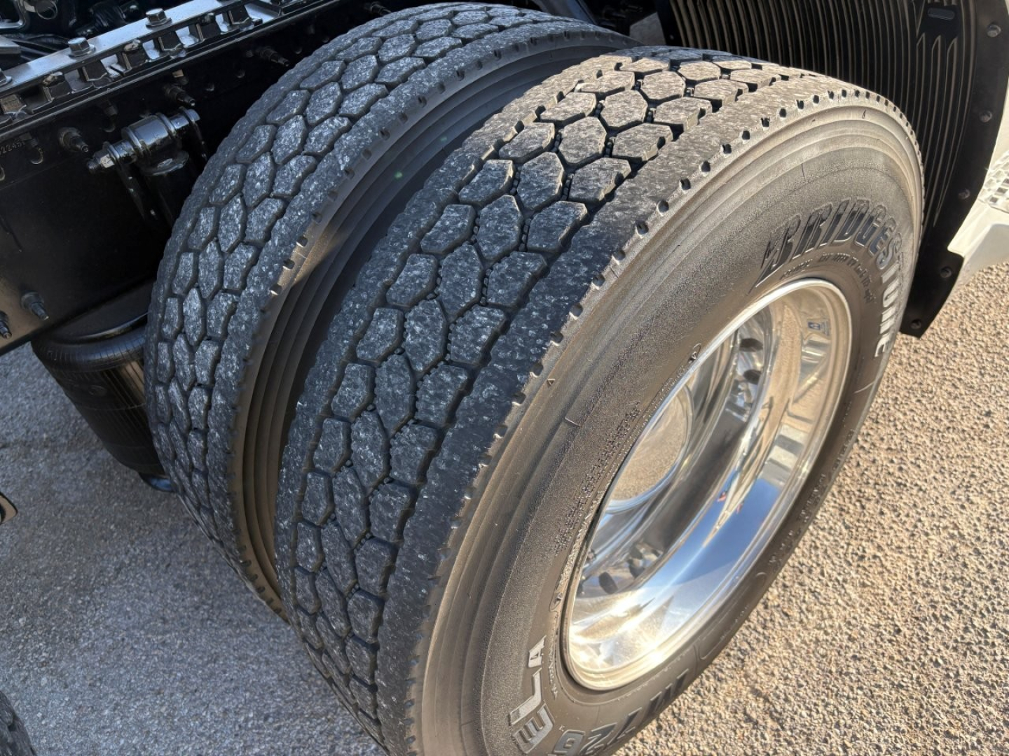 Volvo VNL64T860 truck rear dual tires showing Bridgestone tire brand and chrome wheel.