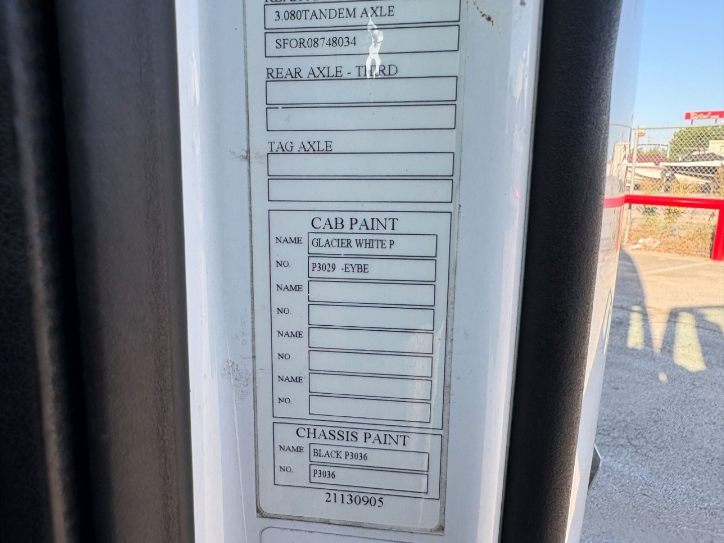 Vehicle identification tag labels on a Volvo truck door frame showing paint and axle information blocks.
